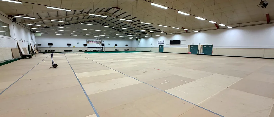 Both greens boarded over, with the walkway between them and the roof of the arena above